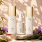 The Essentials Ritual: N° 01 Cleansing Milk, N° 02 Saffron Mist and N° 05 Rich Cream on a stone slab with moss and saffron crocus in warm sunlight